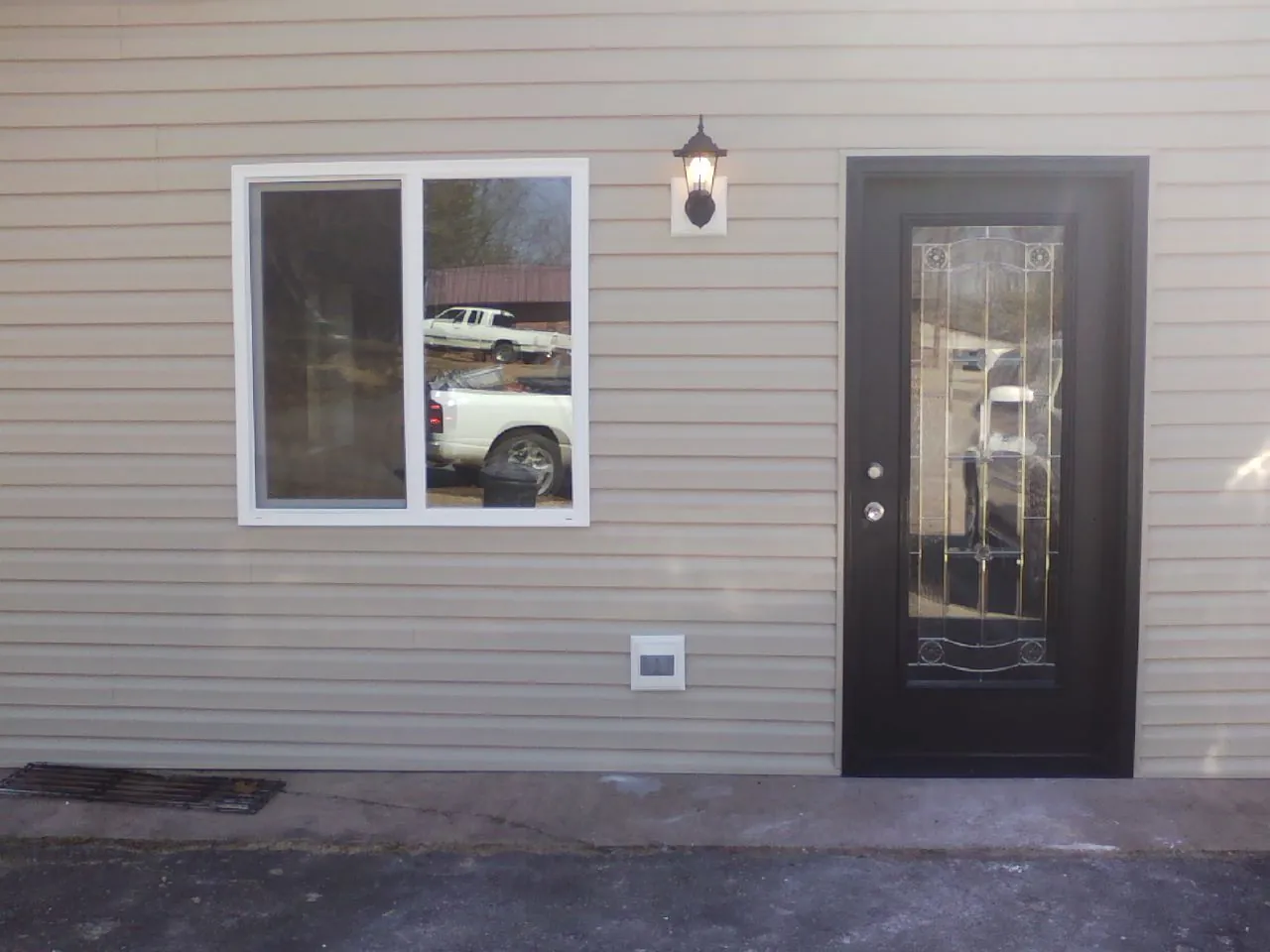 New siding, window and entry door on the side of an addition in Mccleary
